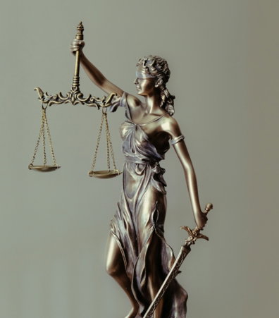 woman-in-gold-dress-holding-sword-figurine.jpg woman in gold dress holding sword figurine